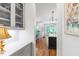 Hallway view of a stylish kitchen with gray cabinets, white countertops, and a view into the light filled breakfast nook at 197 Boxwood Dr, Pittsboro, NC 27312