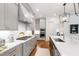 Modern kitchen with gray cabinets, white countertops, stainless steel appliances, and stylish lighting fixtures at 197 Boxwood Dr, Pittsboro, NC 27312