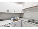 Clean laundry room with modern appliances, granite counters, and custom cabinets at 197 Boxwood Dr, Pittsboro, NC 27312