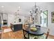 Open concept kitchen with breakfast nook and flowing into the living room with elegant furniture and decor at 197 Boxwood Dr, Pittsboro, NC 27312