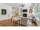 Cozy living room featuring built-in shelves, a stone fireplace, and hardwood flooring at 197 Boxwood Dr, Pittsboro, NC 27312