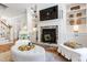 Cozy living room featuring a stone fireplace, built-in shelves, and comfortable seating, creating a warm atmosphere at 197 Boxwood Dr, Pittsboro, NC 27312