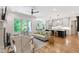 Open-concept living space with hardwood floors, a fireplace, and seamless flow to the modern kitchen at 197 Boxwood Dr, Pittsboro, NC 27312