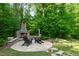 Outdoor stone fireplace with seating area, perfect for entertaining and enjoying nature at 197 Boxwood Dr, Pittsboro, NC 27312