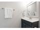 Stylish powder room features dark vanity and bright mirror at 197 Boxwood Dr, Pittsboro, NC 27312