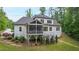 Stunning rear exterior of a home featuring a screened porch and elevated deck for outdoor enjoyment at 197 Boxwood Dr, Pittsboro, NC 27312