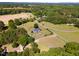 Comprehensive aerial view of an estate featuring home, pool, multiple outbuildings, driveway and expansive grounds at 198 Fore View Ln, Sanford, NC 27332