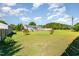 Expansive backyard featuring lush green grass, a home, a swimming pool and a storage shed at 198 Fore View Ln, Sanford, NC 27332