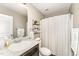 A well-lit bathroom featuring shelves, a tub with shower, and a sink with a vanity at 198 Fore View Ln, Sanford, NC 27332