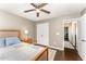 Bedroom featuring a ceiling fan, double closet and hall access at 198 Fore View Ln, Sanford, NC 27332