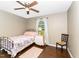 This cozy bedroom features a fan and a window with a view to the outside at 198 Fore View Ln, Sanford, NC 27332