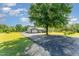 Home exterior featuring a spacious yard and private driveway with large shade tree at 198 Fore View Ln, Sanford, NC 27332