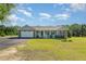 Charming one-story home featuring a manicured lawn, attached garage, and inviting front porch at 198 Fore View Ln, Sanford, NC 27332