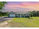 Charming one-story home featuring a manicured lawn, attached garage, and inviting front porch at 198 Fore View Ln, Sanford, NC 27332