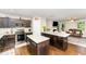 Modern kitchen boasts an island with seating, dark cabinets, and stainless steel appliances at 198 Fore View Ln, Sanford, NC 27332