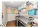 Functional laundry room featuring a modern washer and dryer, shelving for storage, and hardwood floors at 198 Fore View Ln, Sanford, NC 27332