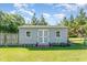 Well-maintained shed with double doors and windows, providing ample storage space, surrounded by green lawn at 198 Fore View Ln, Sanford, NC 27332