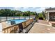 Outdoor swimming pool surrounded by a wooden deck with patio seating, perfect for summer entertainment at 198 Fore View Ln, Sanford, NC 27332