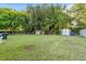 Wide backyard featuring a fenced area and ample green space with storage shed at 204 Heck St, Raleigh, NC 27601