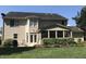 A backyard featuring a patio, screened porch, and lush green lawn at 210 Shillings Chase Dr, Cary, NC 27518