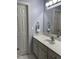 Bathroom featuring a white vanity with chrome fixtures, a mirror, and a white cabinet for storage at 210 Shillings Chase Dr, Cary, NC 27518