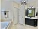Nicely appointed bathroom with soaking tub, vanity, and linen storage at 210 Shillings Chase Dr, Cary, NC 27518