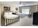 Sunlit bedroom featuring neutral carpeting, ceiling fan, and two beds at 210 Shillings Chase Dr, Cary, NC 27518