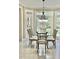 Bright dining area with a glass table and decorative light fixture at 210 Shillings Chase Dr, Cary, NC 27518