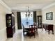 Traditional dining room with elegant chandelier, dark wood furniture, and decorative molding at 210 Shillings Chase Dr, Cary, NC 27518