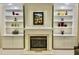 This fireplace is surrounded by custom built-in shelving, offering ample space for displaying decorative items at 210 Shillings Chase Dr, Cary, NC 27518