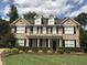 Charming two-story brick home with a manicured lawn and beautiful landscaping at 210 Shillings Chase Dr, Cary, NC 27518