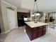 Kitchen island and custom cabinets adjacent to the staircase at 210 Shillings Chase Dr, Cary, NC 27518