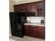 Kitchen with wood cabinets, stainless steel appliances, and a built-in wine rack at 210 Shillings Chase Dr, Cary, NC 27518