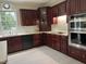 Kitchen with stainless appliances, wood cabinets, and white subway tile backsplash at 210 Shillings Chase Dr, Cary, NC 27518