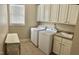 Bright laundry room with white cabinets, sink, and washer/dryer at 210 Shillings Chase Dr, Cary, NC 27518