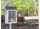 Charming little library and bench surrounded by mature trees providing a quite place to read at 210 Shillings Chase Dr, Cary, NC 27518