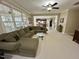 Bright living room features an open layout and a large sectional sofa with views of the backyard at 210 Shillings Chase Dr, Cary, NC 27518