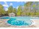 Community pool featuring a spacious sundeck with ample seating and a bath house surrounded by mature trees at 210 Shillings Chase Dr, Cary, NC 27518
