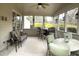 Inviting screened porch featuring a ceiling fan, various seating areas, and views of the surrounding greenery at 210 Shillings Chase Dr, Cary, NC 27518