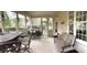 Relaxing screened-in porch with comfortable seating, neutral rug, and views of the backyard landscaping at 210 Shillings Chase Dr, Cary, NC 27518