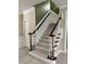 Carpeted staircase features white risers and dark wood handrail at 210 Shillings Chase Dr, Cary, NC 27518