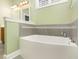 Bathroom featuring a modern soaking tub with tiled surround and fixtures at 2205 Karns Pl, Raleigh, NC 27614