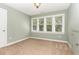 Cozy bedroom with neutral carpet, soft green walls, and plenty of natural light at 2205 Karns Pl, Raleigh, NC 27614