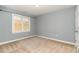 Comfortable bedroom with neutral carpet, blue-gray walls, and a window at 2205 Karns Pl, Raleigh, NC 27614
