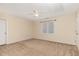 Neutral bedroom features a ceiling fan, window, and carpeted floors at 2205 Karns Pl, Raleigh, NC 27614