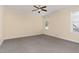 Bedroom with neutral carpet, cream-colored walls, ceiling fan, and natural light from windows at 2205 Karns Pl, Raleigh, NC 27614