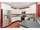 Modern kitchen featuring white cabinets, stainless steel appliances, and sleek countertops at 2205 Karns Pl, Raleigh, NC 27614
