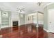 Spacious living room with built-in shelving, fireplace, hardwood floors and decorative columns at 2205 Karns Pl, Raleigh, NC 27614