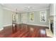 Open-concept living area featuring hardwood floors, fireplace, and large windows at 2205 Karns Pl, Raleigh, NC 27614
