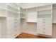 Spacious walk-in closet with custom white shelving and drawers at 2205 Karns Pl, Raleigh, NC 27614